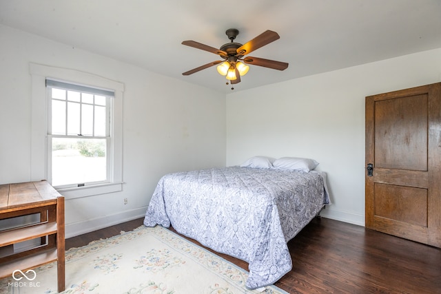 bedroom with dark wood-type flooring and ceiling fan