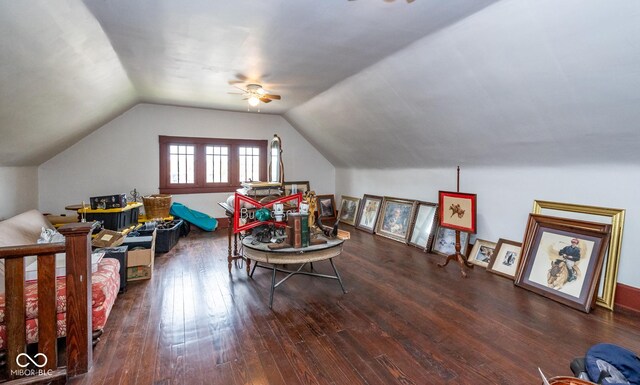 rec room featuring a ceiling fan, vaulted ceiling, and dark wood-type flooring