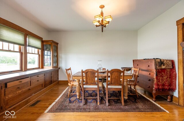 1457 Fairfield Ave, Indianapolis, IN 46205 - dining area featuring an inviting chandelier, wood finished floors, and baseboards