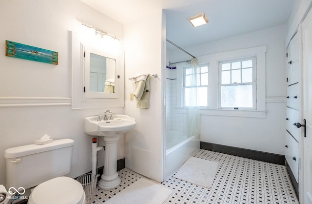 bathroom with washtub / shower combination and toilet