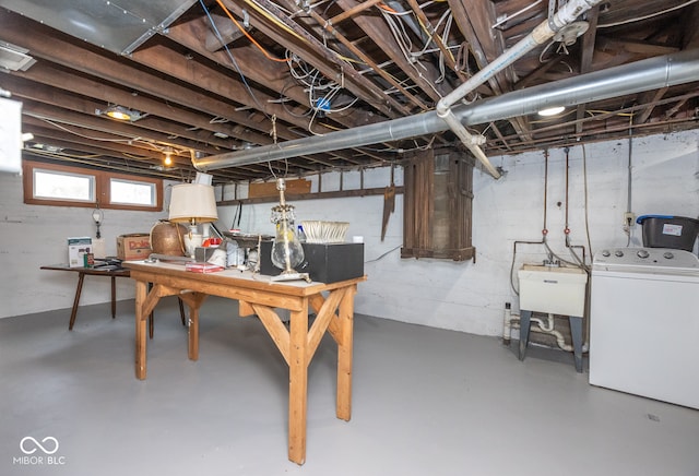 basement featuring washer / dryer and sink