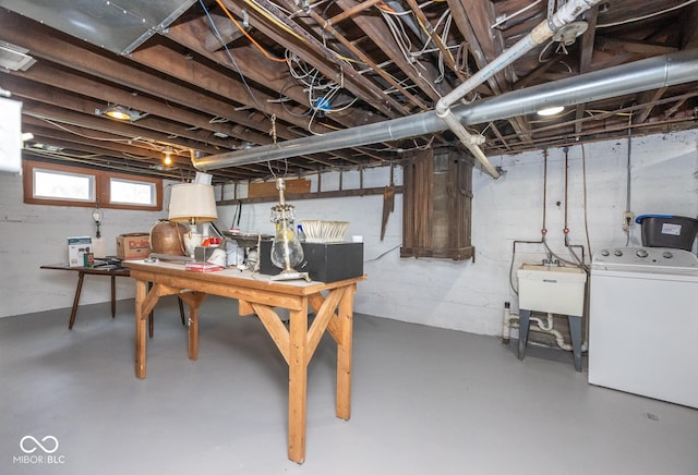 basement featuring a sink and washer / clothes dryer
