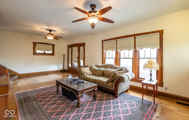 living room with hardwood / wood-style flooring and ceiling fan