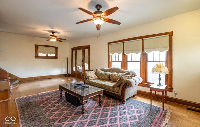 1457 Fairfield Ave, Indianapolis, IN 46205 - living area with baseboards, a ceiling fan, wood finished floors, and visible vents