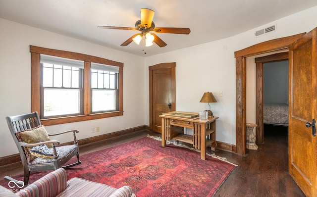sitting room featuring wood finished floors, visible vents, a ceiling fan, and baseboards