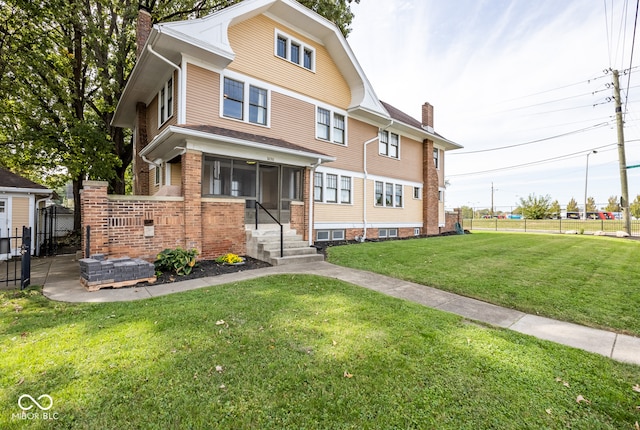 view of front facade with a front lawn and a sunroom