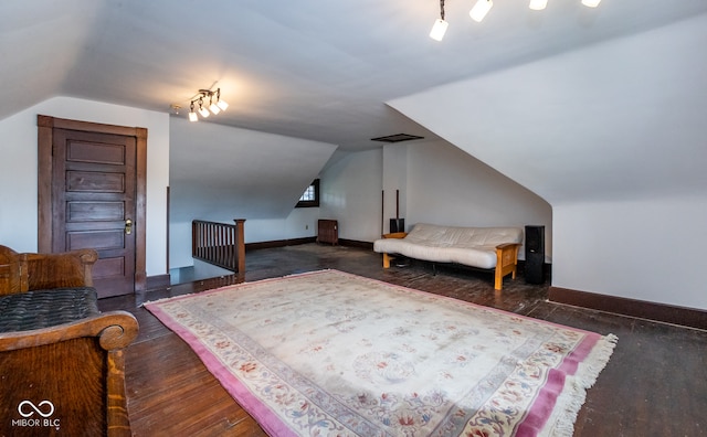 bedroom featuring dark wood-type flooring and vaulted ceiling