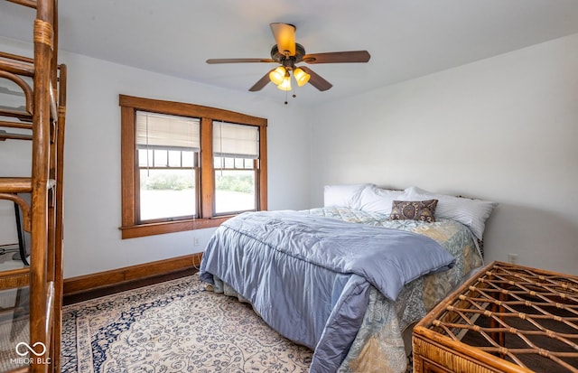 bedroom featuring light wood-type flooring, baseboards, and ceiling fan