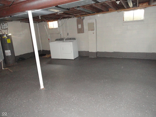 basement featuring electric panel, independent washer and dryer, electric water heater, and plenty of natural light