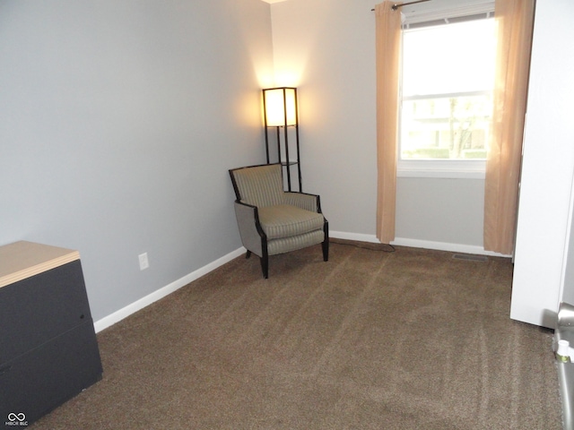 living area with dark carpet