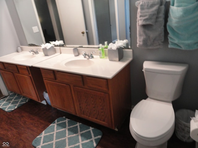 bathroom with vanity, hardwood / wood-style floors, and toilet