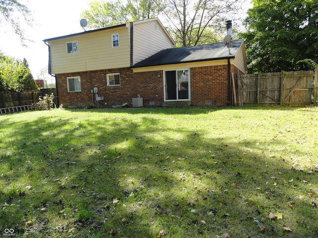 rear view of property featuring a yard