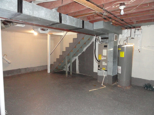 basement featuring water heater and heating unit