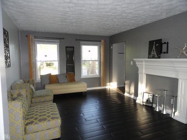 living room with a textured ceiling and dark wood-type flooring