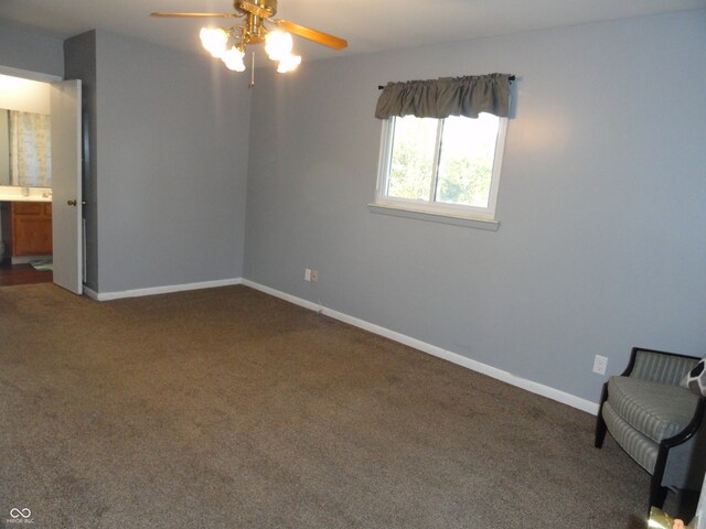 unfurnished bedroom featuring ceiling fan, connected bathroom, and dark carpet