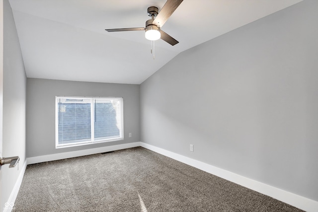 carpeted spare room featuring lofted ceiling and ceiling fan