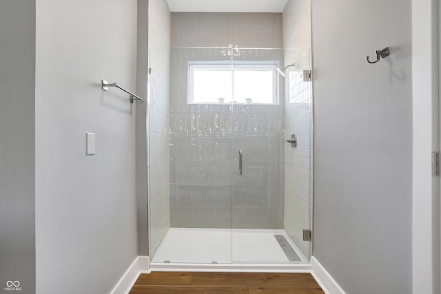 bathroom with walk in shower and hardwood / wood-style flooring