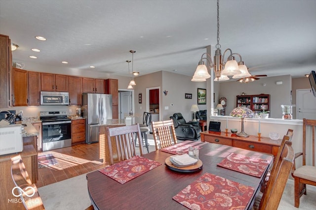 dining area featuring an inviting chandelier and light hardwood / wood-style flooring