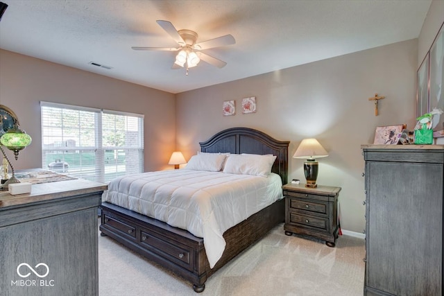 bedroom featuring ceiling fan and light colored carpet