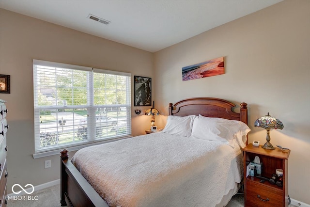 carpeted bedroom featuring multiple windows