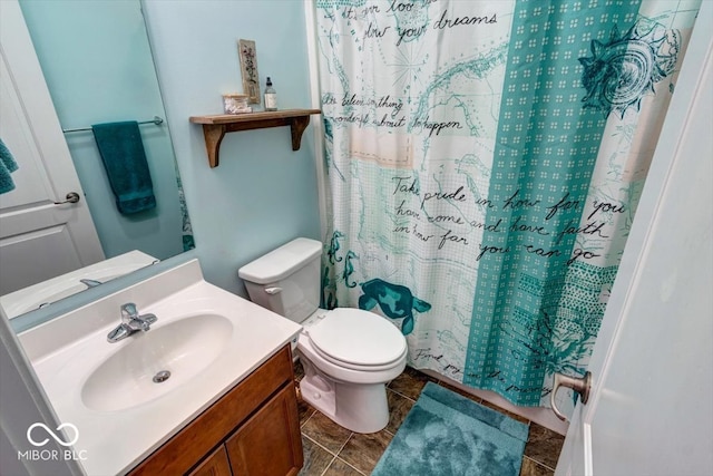 bathroom with tile patterned flooring, curtained shower, vanity, and toilet