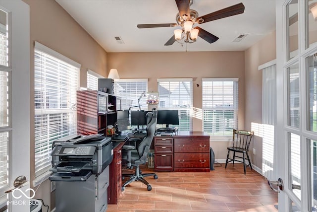 home office featuring ceiling fan and light hardwood / wood-style flooring