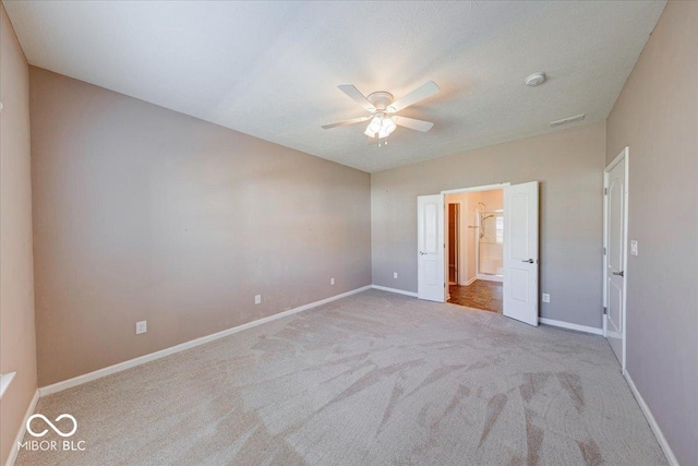 unfurnished bedroom featuring visible vents, baseboards, carpet floors, and ceiling fan