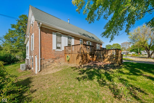 rear view of property with central AC, a yard, and a deck