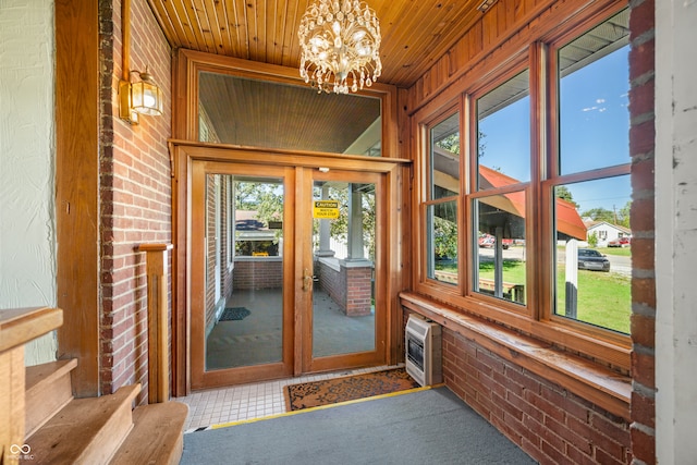 doorway featuring wooden ceiling, heating unit, and a notable chandelier