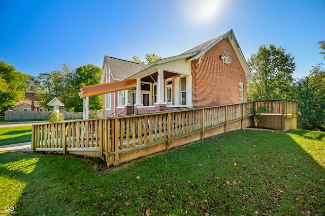 rear view of property with a yard