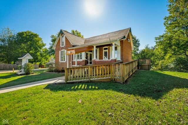 exterior space featuring a lawn and a porch