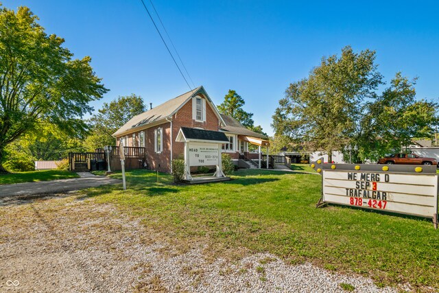 view of side of property with a lawn