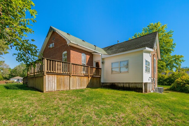 rear view of property with a lawn and a deck