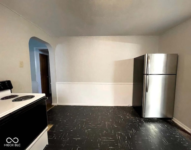 kitchen with stainless steel fridge and white range with electric cooktop