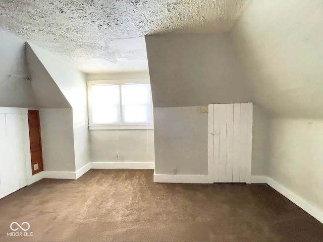 bonus room featuring a textured ceiling, lofted ceiling, and carpet