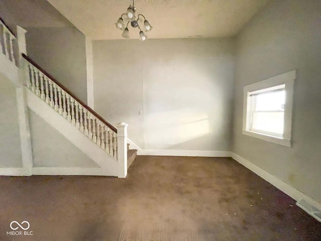 interior space featuring carpet floors and a notable chandelier