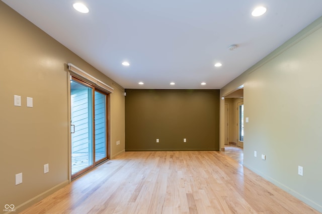 empty room featuring ornamental molding and light hardwood / wood-style floors