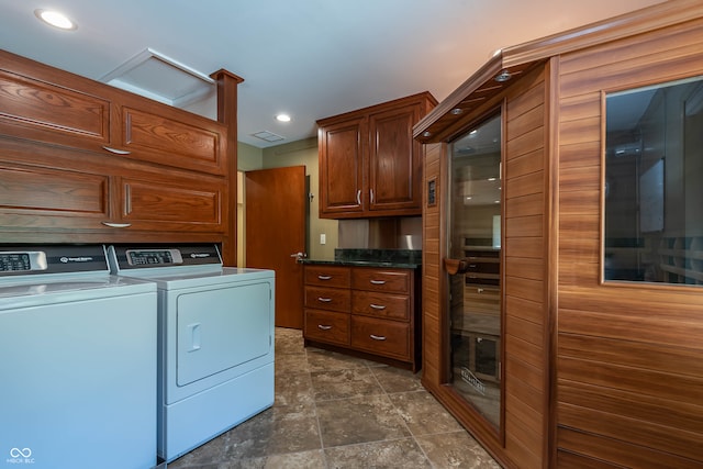 washroom featuring cabinets and separate washer and dryer