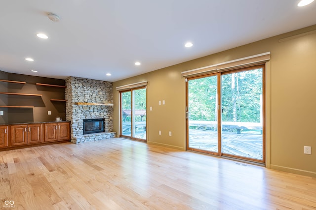 unfurnished living room featuring light hardwood / wood-style floors and plenty of natural light