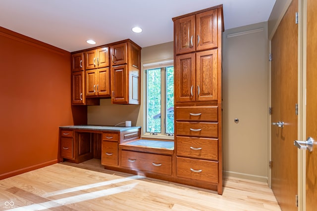 kitchen with light hardwood / wood-style floors and ornamental molding