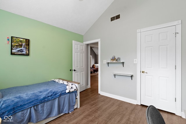 603 Ophelia Dr, Avon, IN 46123 - bedroom with wood finished floors, high vaulted ceiling, and baseboards