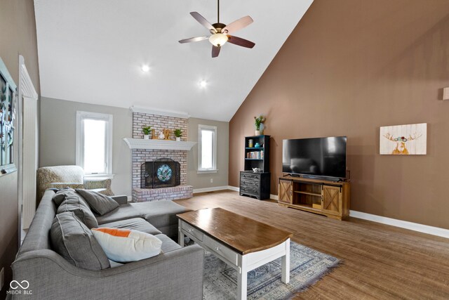 603 Ophelia Dr, Avon, IN 46123 - living room featuring ceiling fan, high vaulted ceiling, wood finished floors, baseboards, and a fireplace