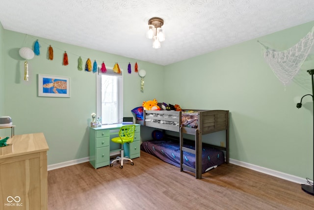 603 Ophelia Dr, Avon, IN 46123 - bedroom with wood finished floors, baseboards, and a textured ceiling
