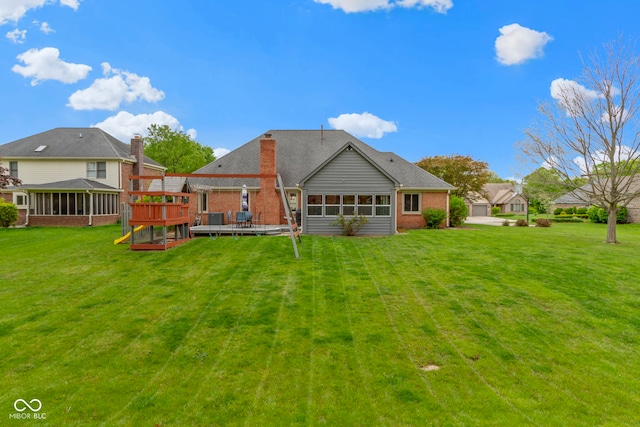 603 Ophelia Dr, Avon, IN 46123 - rear view of property with a sunroom, a wooden deck, brick siding, and a yard