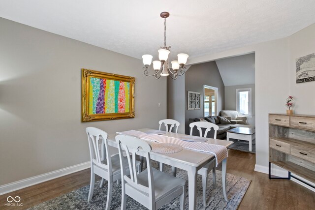 603 Ophelia Dr, Avon, IN 46123 - dining area with wood finished floors, a chandelier, baseboards, and lofted ceiling