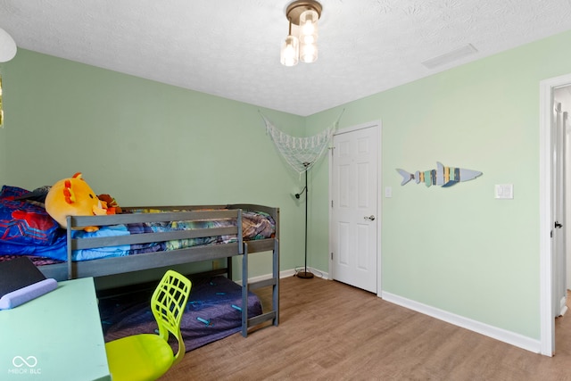 603 Ophelia Dr, Avon, IN 46123 - bedroom featuring wood finished floors, baseboards, and a textured ceiling
