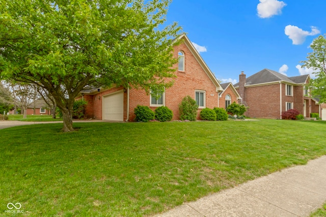 603 Ophelia Dr, Avon, IN 46123 - view of front facade featuring brick siding, a front yard, an attached garage, a chimney, and driveway