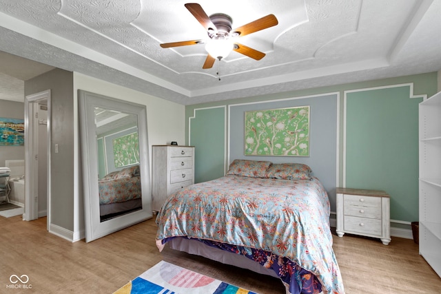 603 Ophelia Dr, Avon, IN 46123 - bedroom featuring wood finished floors, baseboards, a raised ceiling, and ceiling fan