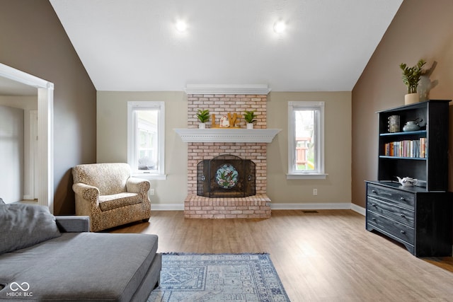 603 Ophelia Dr, Avon, IN 46123 - living area with vaulted ceiling, wood finished floors, plenty of natural light, and baseboards