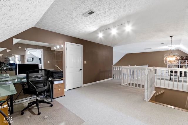 603 Ophelia Dr, Avon, IN 46123 - carpeted office with vaulted ceiling, a chandelier, baseboards, a textured ceiling, and rail lighting